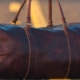 Close up of brown leather holdall in centre of tarmacced road