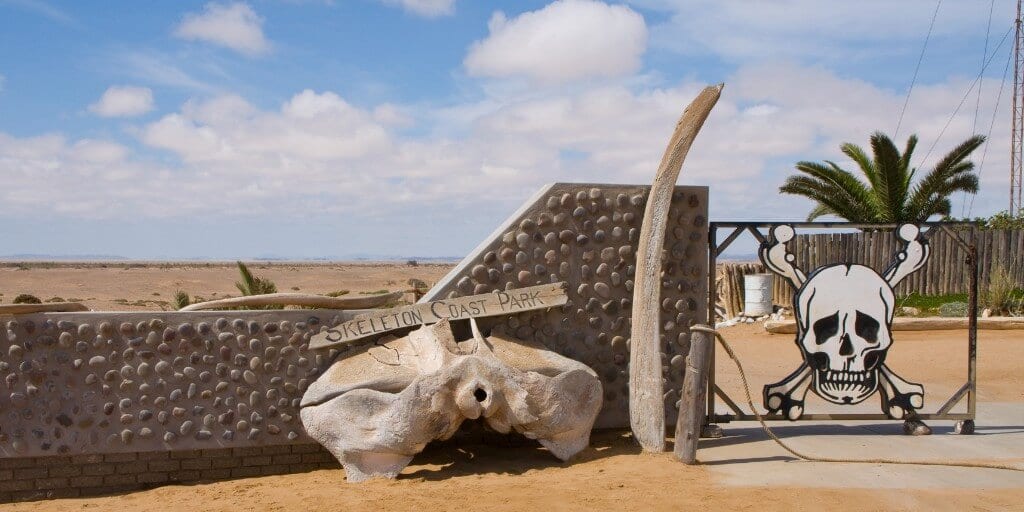 Entrance gate to Skeleton Coast National Park - complete with skull and crossbones and elephant bones