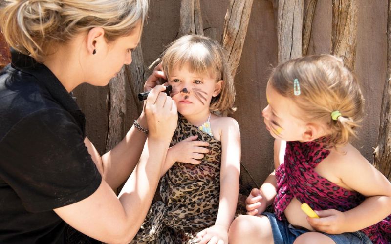 Kids having their faces painted at the Junior Rangers programme at Madikwe Hills Private Game Lodge - one of the best places for family safaris in South Africa.